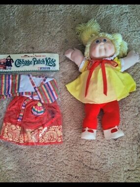 CPK DOLL WITH ADOPTION PAPER (FILLEDOUT) IN ORIGINAL OUTFIT. EXCELLENT CONDITION